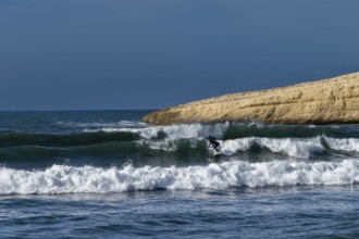Santa Caterina di Pittinuri, Italy, 13 December, 2022: surfer enjoying good waves on the west coast