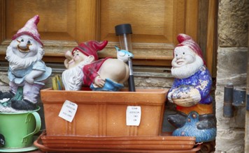 Garden gnomes in front of a door in a French village, 2019