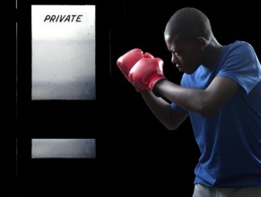 Black African American teenage boy athletic boxer with boxing gloves