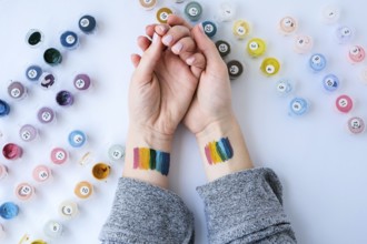 Rainbow LGBTQ flag painted on hand. Support for lgbt community. Honour of pride month. Connecting