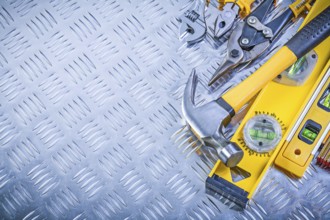 Set of construction tools on grooved metal plate maintenance concept