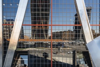 Madrid, Spain, March 20, 2017: Low angle view of The Gate of Europe towers and reflections. They