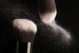 Cosmetics brush and colorful makeup powder