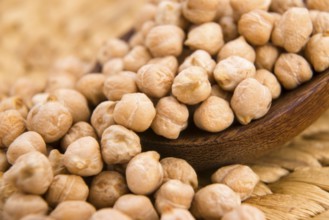 Dried white chickpeas ceci on the wooden spoon, lodz, poland