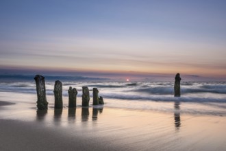Groyne on the coast of the Baltic Sea with sunset