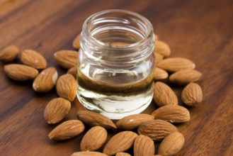 Almond oil with nuts on wooden background, lodz, poland