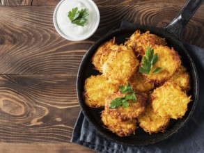 Potatoes pancakes latkes, flapjacks, hash brown or potato vada with white greek yoghurt or sour