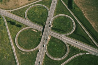 Clover or daisy type of road junction. Aerial top down view of beautiful highway road junction in