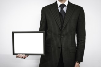 Businessman with a white board. Shooting Location: Tokyo metropolitan area