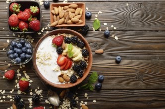 Flat lay top view at Fruit healthy muesli with banana strawberry almonds and blackberry with yogurt