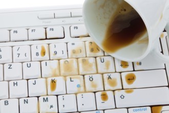 Cup of coffee spilled on a computer keyboard. Damage for insurance, Cup of coffee spilled on a