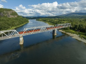 Railroad bridge with 4 permanently parked train wagons over the Namsen river in Norway