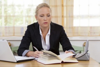 Successful young entrepreneur at her desk with Bruch and Laptop Computer Austria
