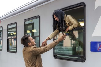 Parr arriving or saying goodbye on a platform at a railway station Austria