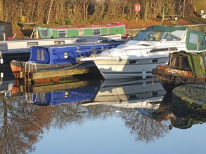 Old narrow boats converted to houseboats moored in the marina at brighouse basin in west yorkshire