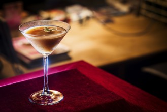 Chocolate and cream martini in cozy bar at night