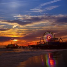 Santa Monica California sunset on Pier Ferrys wheel and reflection on beach wet sand