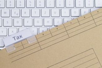 The photo shows a white keyboard with a tax briefcase