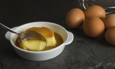 Traditional Brazilian dessert, milk pudding on dark background