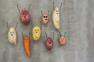 Great concept of healthy eating, vegetables with happy faces with arms up, potato, sweet potato,