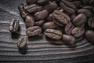Coffee beans on vintage wood board food and drink concept