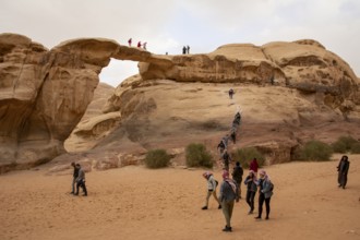 Wadi Rum, Jordan, March 2020: People, tourists, climbing the Um Frouth natural Rock Bridge, Asia