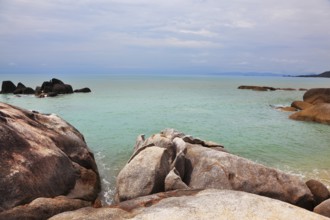 Picturesque coastal cliffs and quiet after a storm sea. Koh Samui