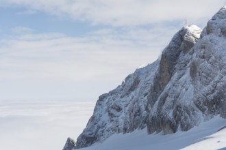 Mountain in the Dachstein region above a blanket of fog