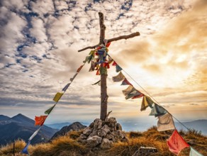 Wood cross on a mountain peak