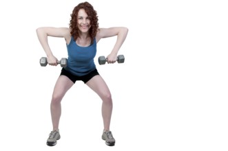 A beautiful young woman using weights during a workout