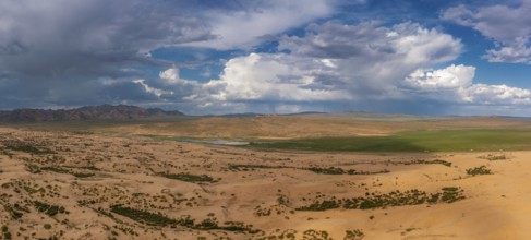 Aerial panorama view of the sand dunes Elsen Tasarhai (Bayan Gobi) desert and mountains in Mongolia