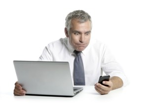Surprised senior businessman expression gesture mobile phone laptop gray hair