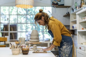 Woman artist crafting with clay and care