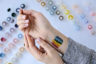 Rainbow LGBTQ flag painted on hand. Support for lgbt community. Honour of pride month. Connecting