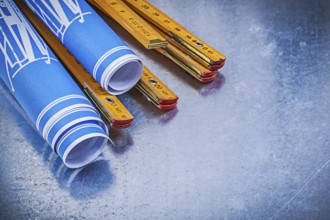 Composition of blue construction drawings wooden meter on metallic background