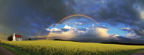 Panorama, chapel and rainbow over a rapeseed field