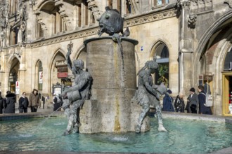 Fish fountain on Marienplatz in front of the New Town Hall in neo-Gothic style, Munich, Upper