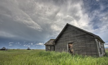 Abandoned Farm with storm clouds in the Canadian Prairie
