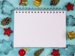 Christmas background with blank notebook, decorations. Copy space. Top view or flat lay. Toned