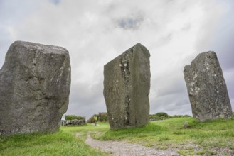 Woman observing the menhirs, Megalithic Circle of Drombeg, The Altar of the Druid-, Rosscarbery