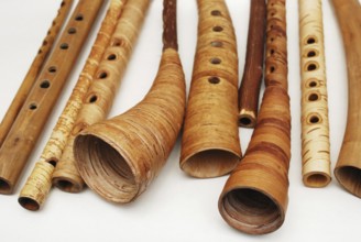 Ancient woodwind folk instruments on a white