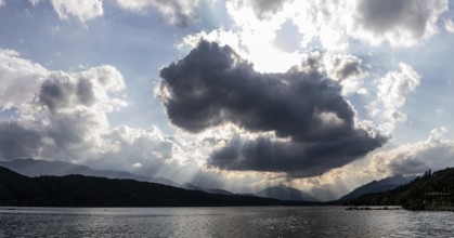 Cloudy mood over Lake Millstättersee, sunbeams from clouds, near Millstatt, Carinthia. Austria