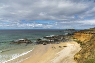 View of St. Ives Bay in Cornwall and small beach near Gwithian with the Godrevy Lighthouse in the