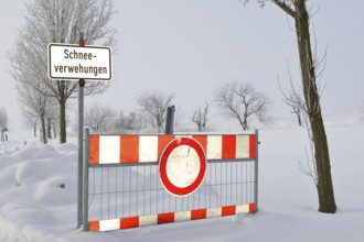 Road blockage through snow drifts. Blocked road