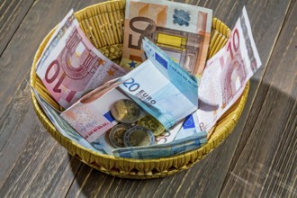 A basket with money for donations and tips Austria