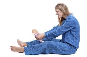 A young Beautiful Woman playing with a baby doll