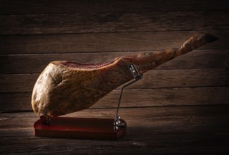 Iberian ham pata negra from Spain on wood background