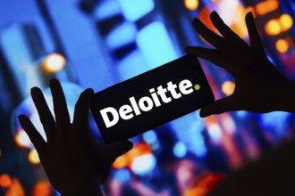 In this photo illustration, the Deloitte Touche Tohmatsu Limited logo is displayed on a smartphone