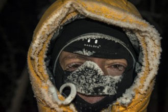 Man with frost-covered hood and balaclava, Abisko, Norrbotten, Lapland, Sweden, December 2012,