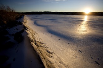 Sunset on Northern Lake in Winter Frozen Saskatchewan